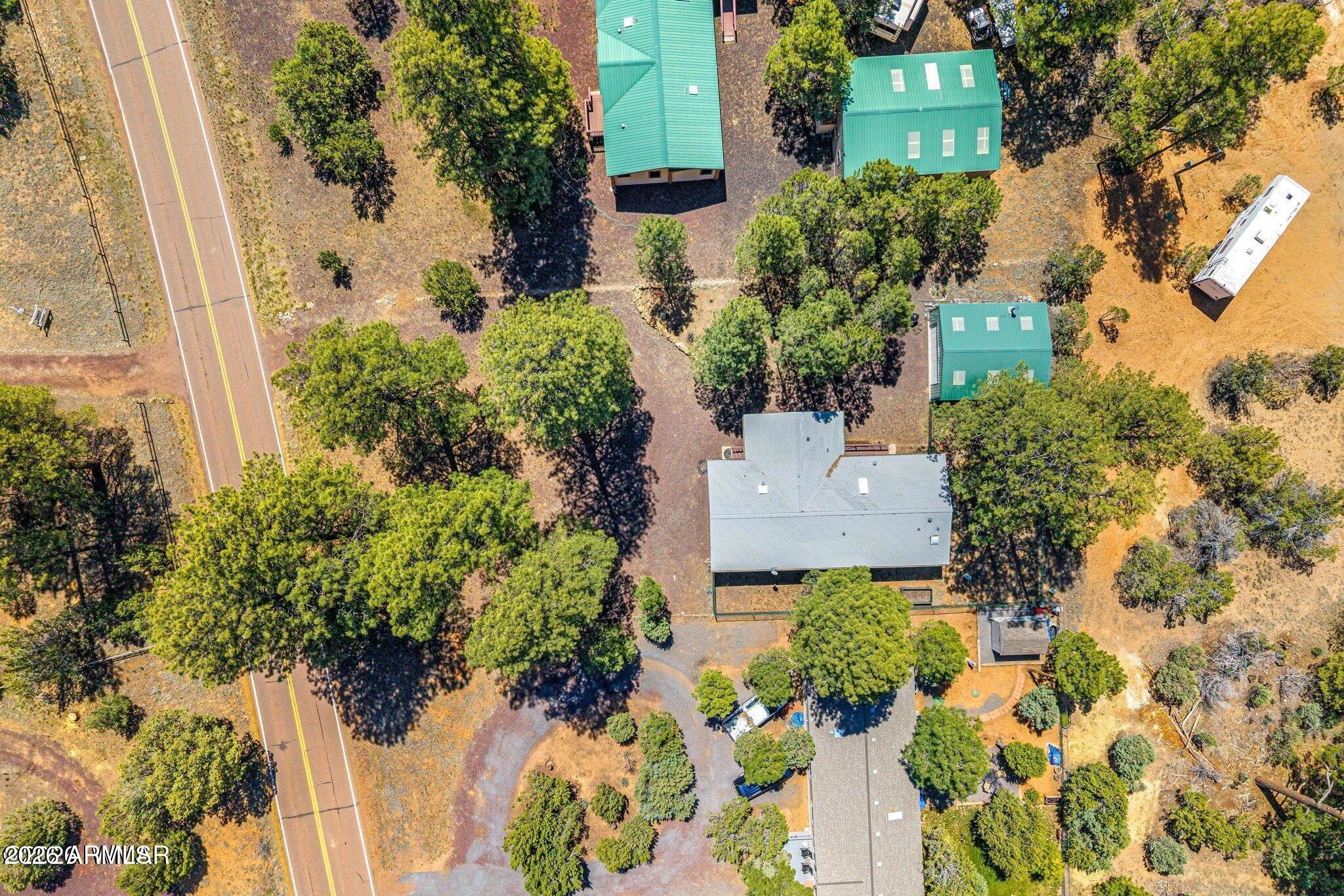2908 Pine Rim Road, Unit LOT 7 Overgaard, AZ 85933 - Photo 21 of 24 an aerial view of a house with a yard and garden