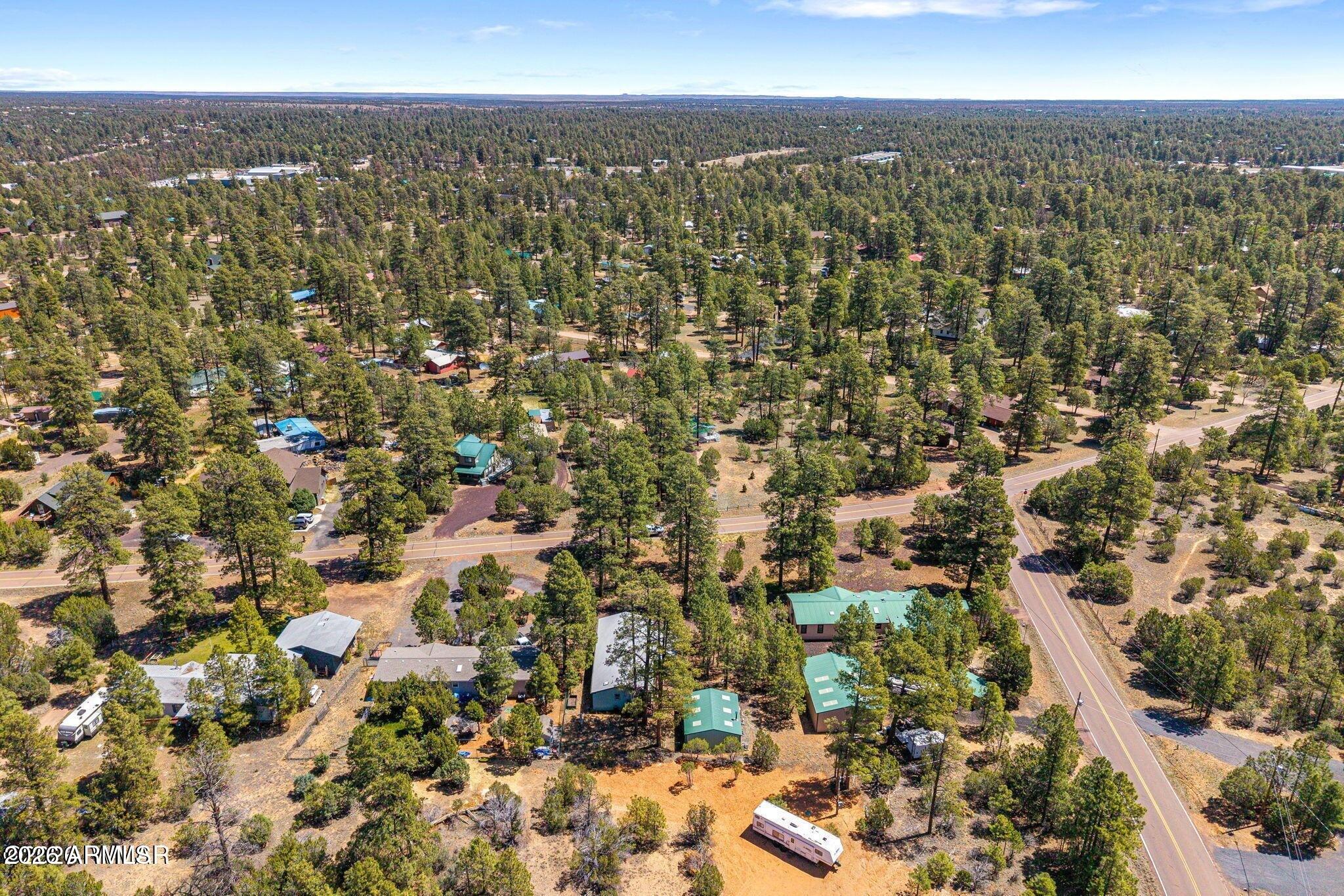 2908 Pine Rim Road, Unit LOT 7 Overgaard, AZ 85933 - Photo 23 of 24 an aerial view of residential building with parking space