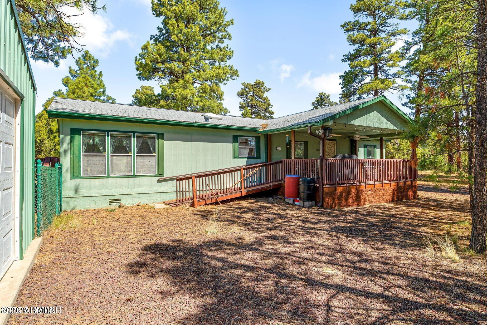 2908 Pine Rim Road, Unit LOT 7 Overgaard, AZ 85933 - Photo 3 of 24 a view of a house with a yard