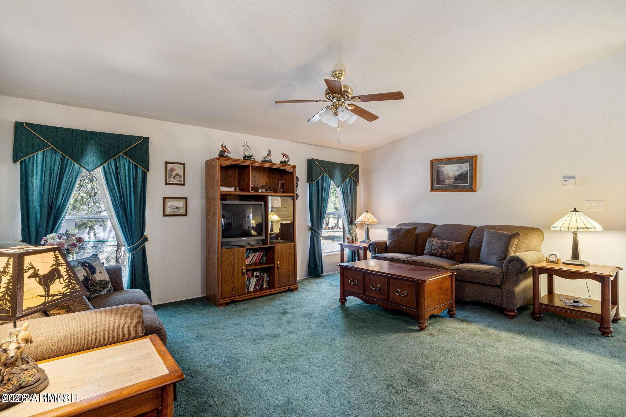 2908 Pine Rim Road, Unit LOT 7 Overgaard, AZ 85933 - Photo 8 of 24 a living room with furniture and a flat screen tv