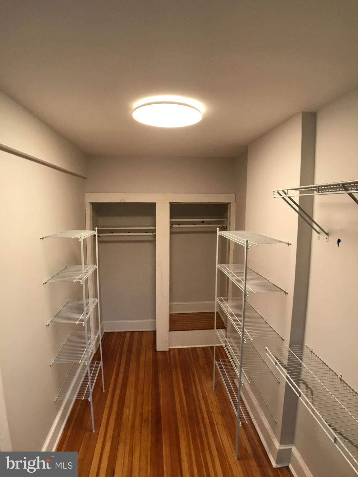 3959 Cloverhill Road Baltimore, MD 21218 - Photo 14 of 27 a view of walk in closet with wooden floor