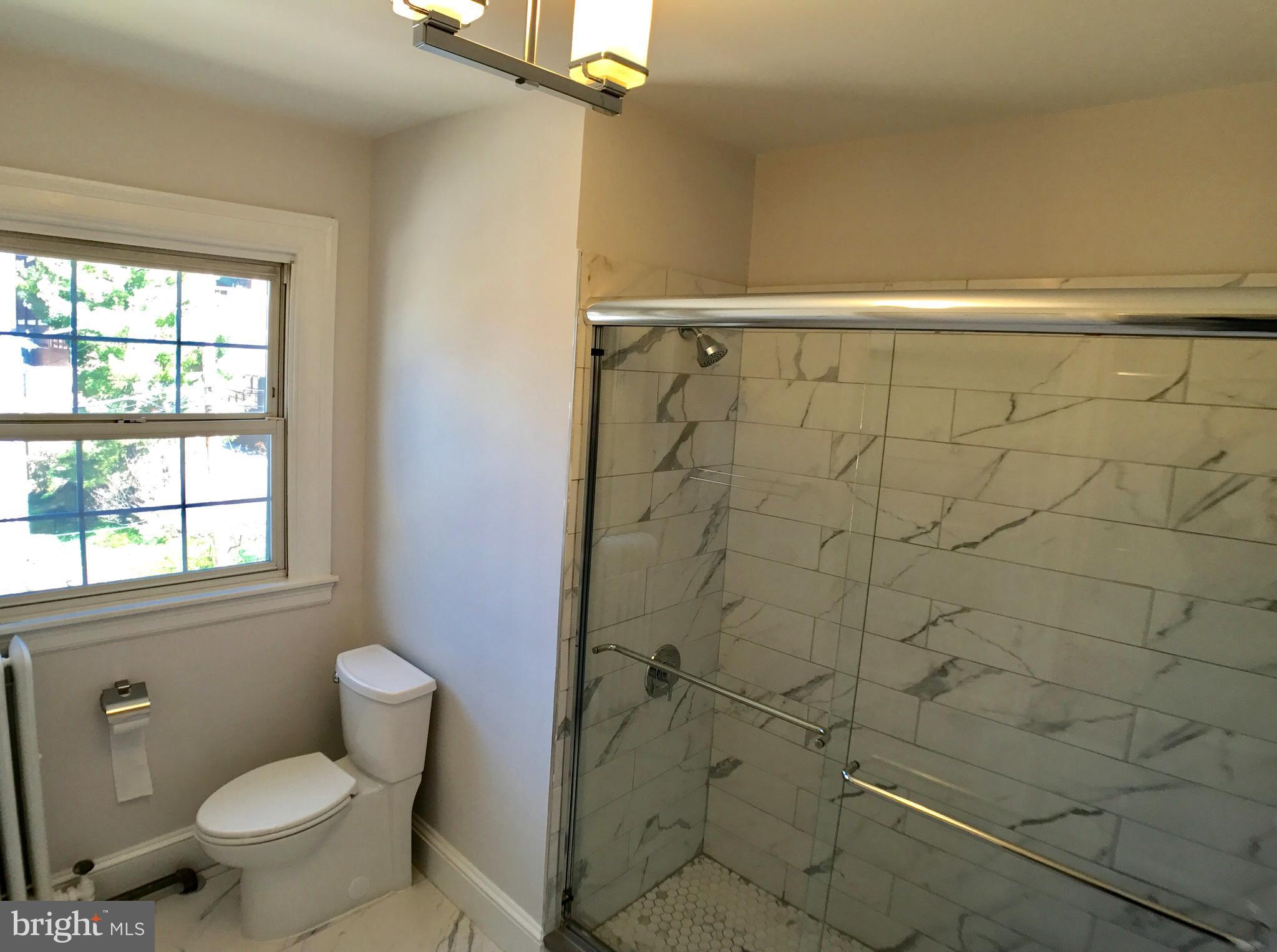 3959 Cloverhill Road Baltimore, MD 21218 - Photo 15 of 27 a bathroom with a toilet and shower