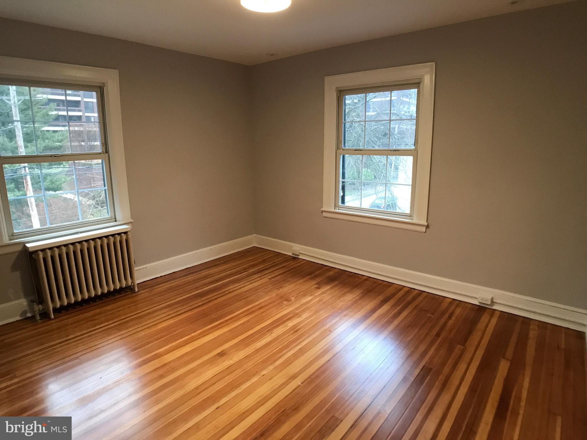 3959 Cloverhill Road Baltimore, MD 21218 - Photo 19 of 27 a view of an empty room with wooden floor and a window