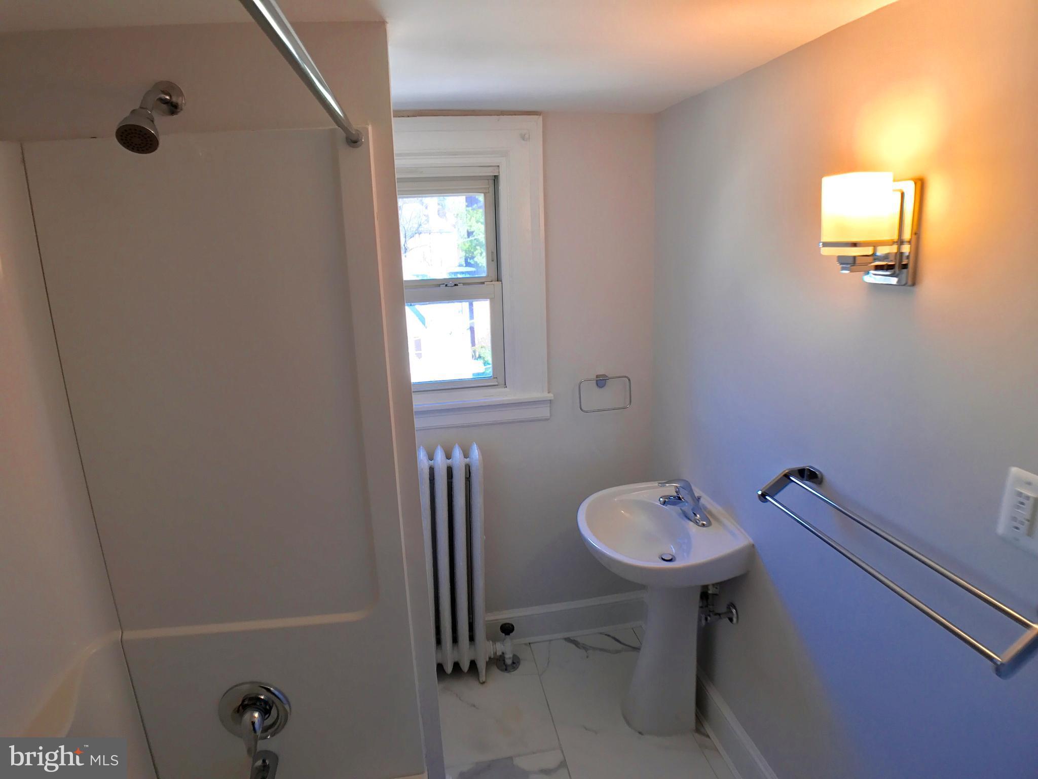 3959 Cloverhill Road Baltimore, MD 21218 - Photo 22 of 27 a bathroom with a sink toilet and a mirror