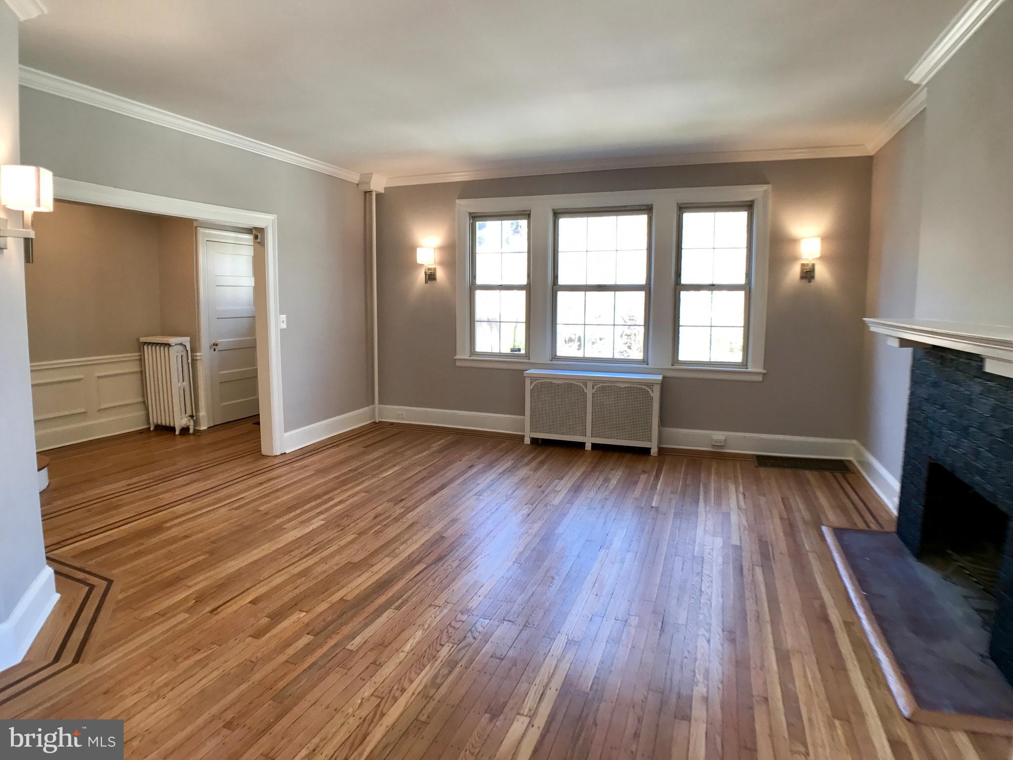 3959 Cloverhill Road Baltimore, MD 21218 - Photo 4 of 27 wooden floor in an empty room with a window
