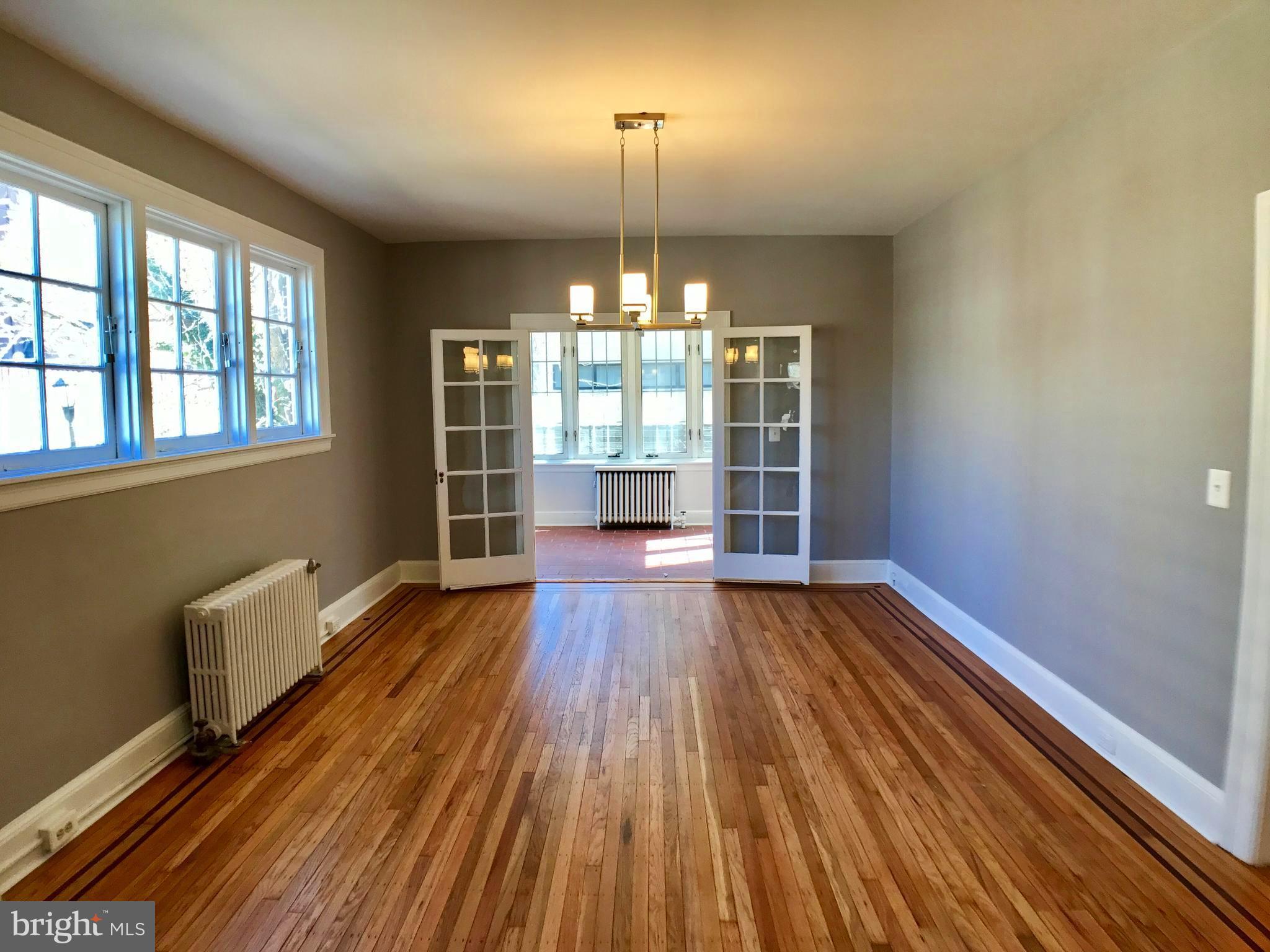 3959 Cloverhill Road Baltimore, MD 21218 - Photo 5 of 27 wooden floor in an empty room with a window