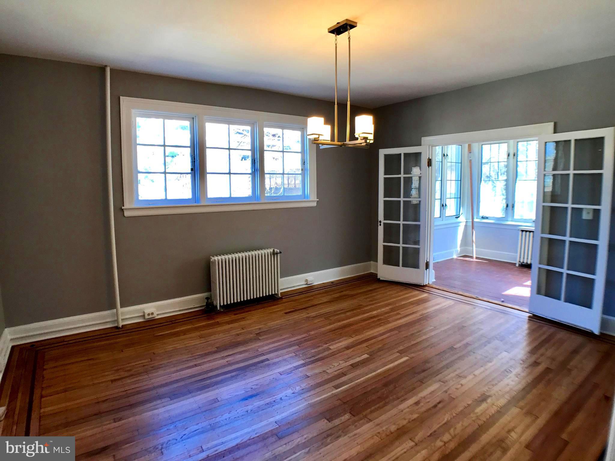 3959 Cloverhill Road Baltimore, MD 21218 - Photo 6 of 27 a view of empty room with wooden floor and window