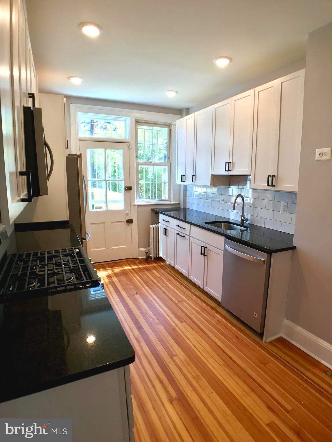 3959 Cloverhill Road Baltimore, MD 21218 - Photo 8 of 27 a kitchen with stainless steel appliances a sink stove and cabinets