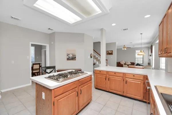 a kitchen with a stove sink and cabinets