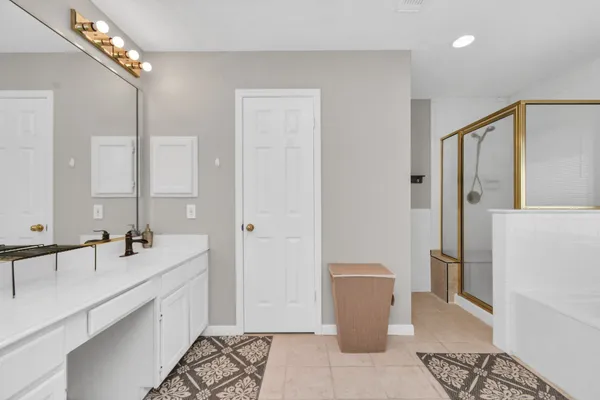a bathroom with double vanity sinks a vanity and a mirror