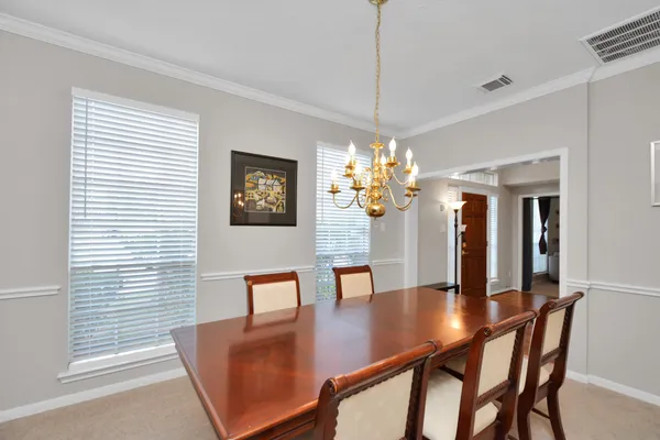 a view of a dining room with furniture and chandelier