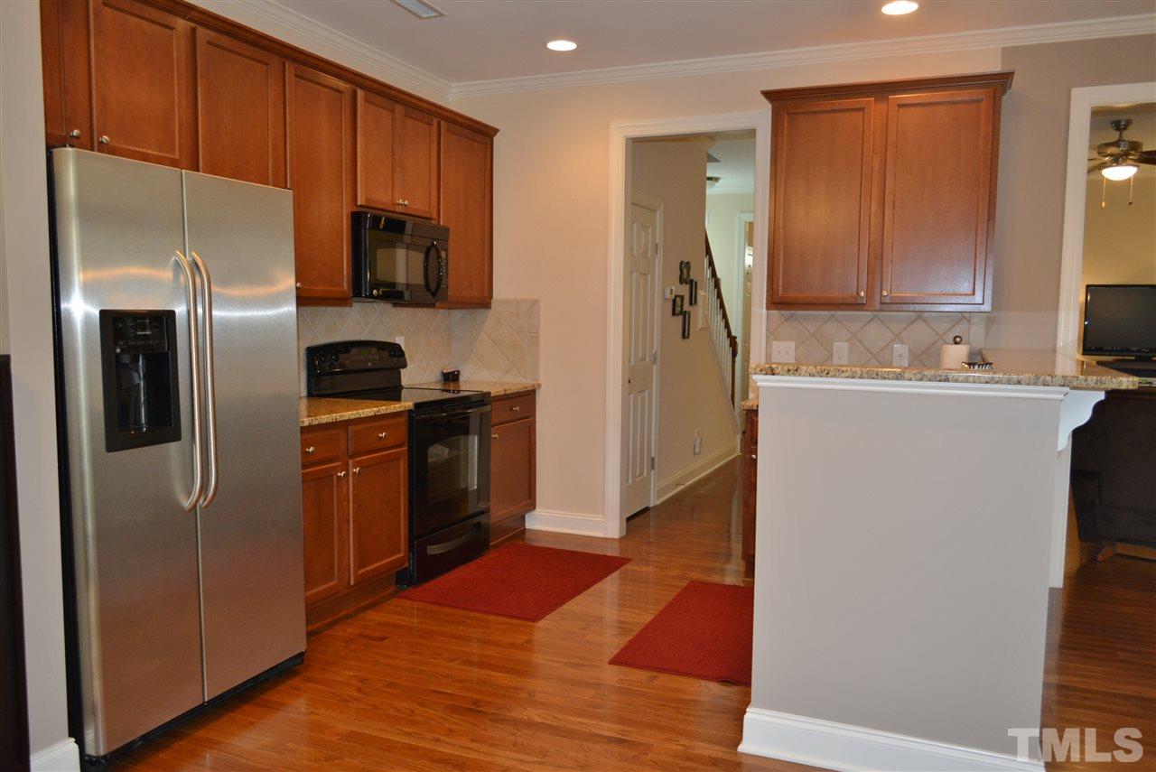 1118 Ileagnes Road Raleigh, NC 27603 - Photo 8 of 25 a kitchen with stainless steel appliances a refrigerator and a stove top oven