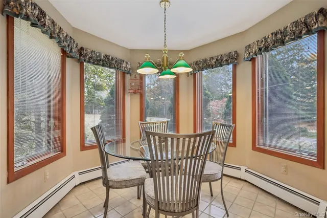 a dining room with furniture and window