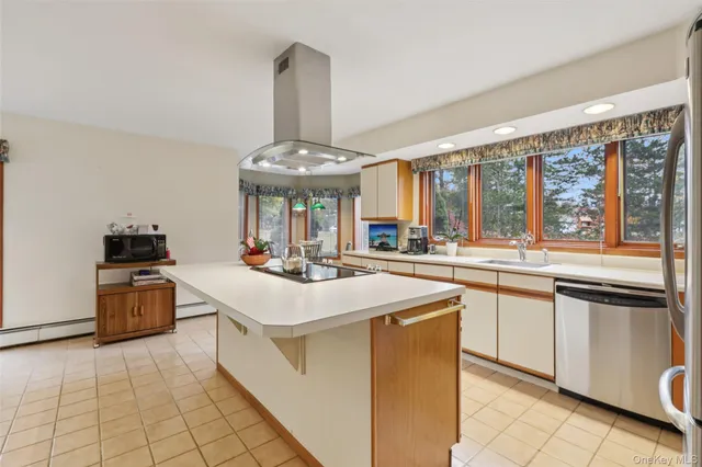 a kitchen with stainless steel appliances a sink stove and a refrigerator