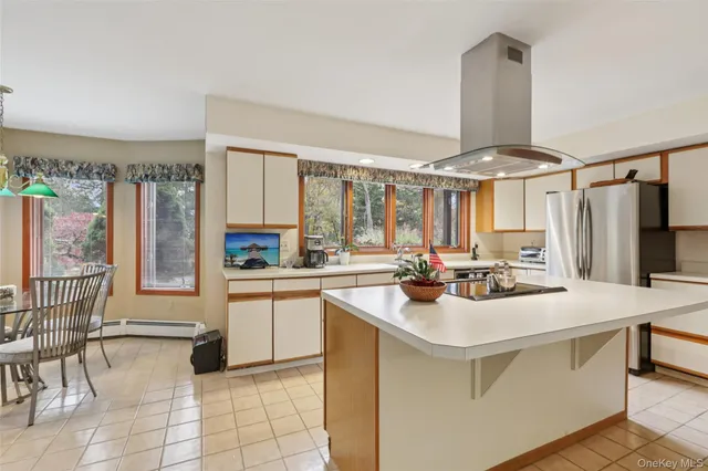 a kitchen with appliances a sink and cabinets