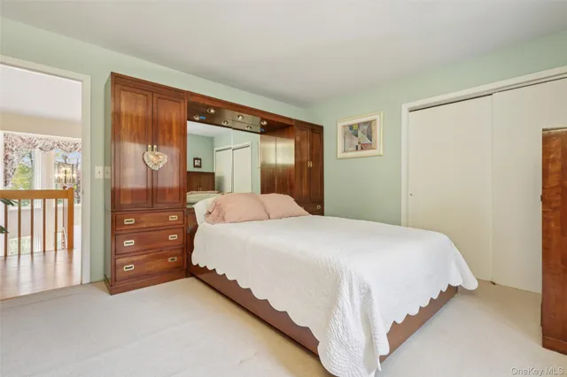 a bedroom with a bed and a large mirror