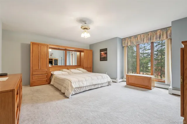 a spacious bedroom with a large bed and a large window