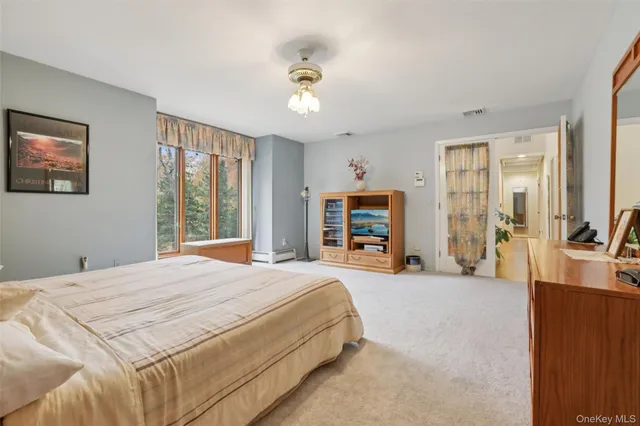 a bedroom with a bed couch and a window