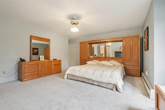 a bed room with a bed and a mirror