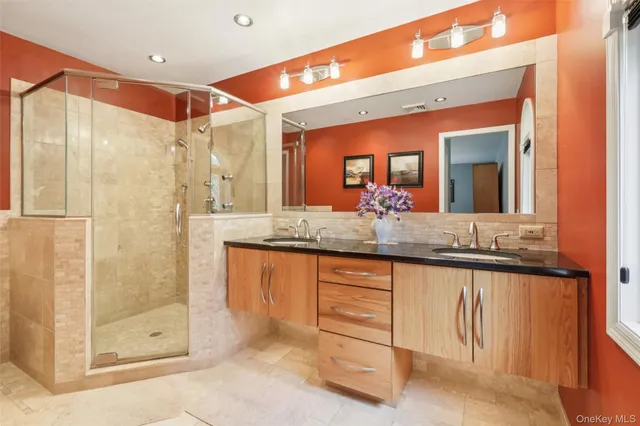 a bathroom with a granite countertop sink mirror and