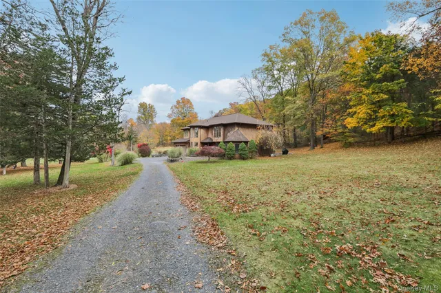 a view of a yard with a house in the background