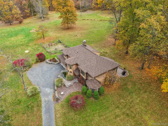 an aerial view of a house with a yard