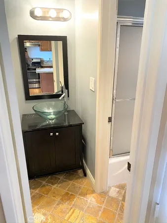 a bathroom with a mirror sink and vanity