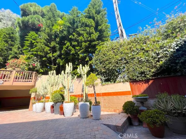 a front view of a house with outdoor seating and garden
