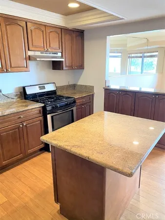 a kitchen with stainless steel appliances granite countertop a sink stove and cabinets