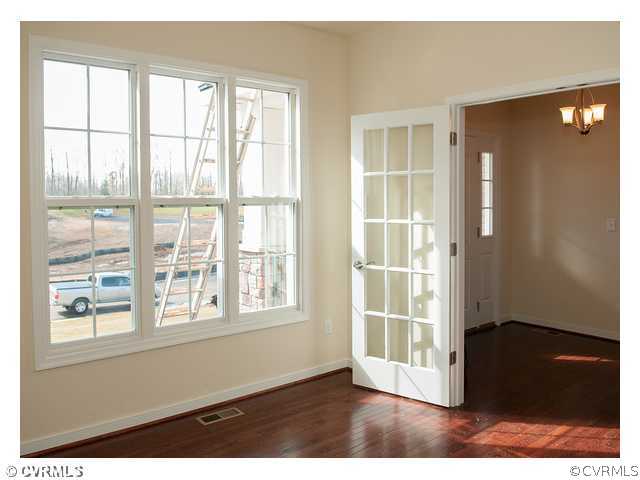 1318 Coalfield Road Midlothian, VA 23114 - Photo 5 of 10 a view of wooden floor and windows in a room