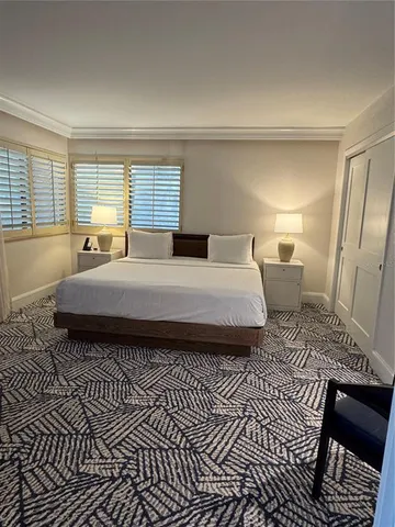 a bedroom with a large bed and a window