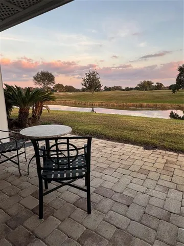 a view of a terrace with lawn chairs
