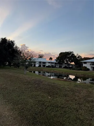 a view of a field with trees in the background