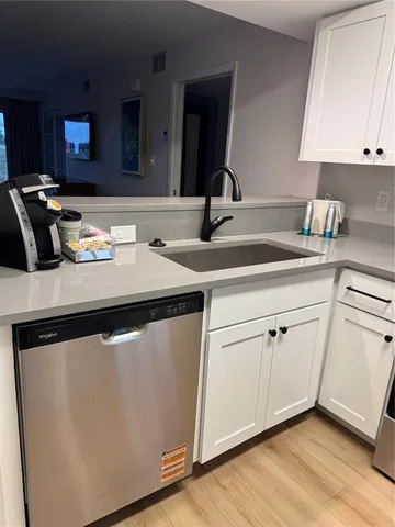 a kitchen with a sink and a refrigerator