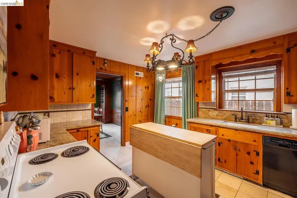 a kitchen with a sink appliances and a window