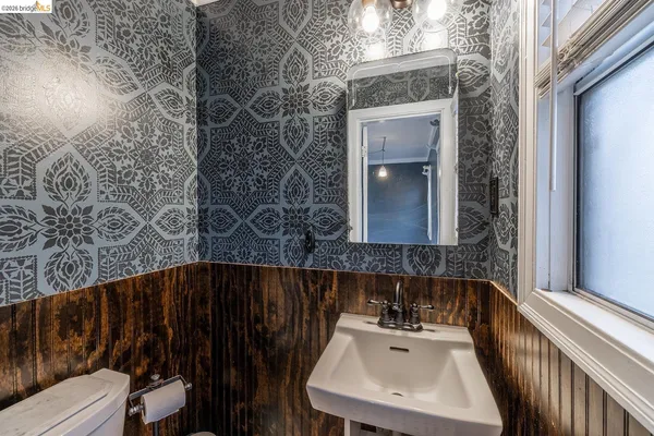 a bathroom with a sink a toilet and mirror