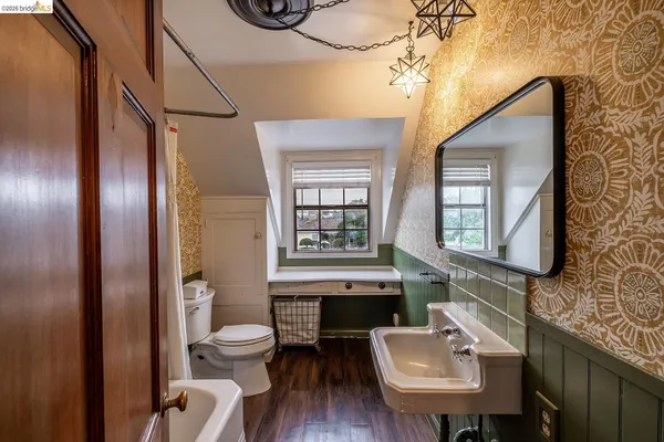 a bathroom with a toilet a sink and mirror