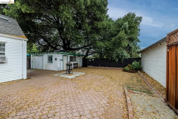 a backyard of a house with basket ball court