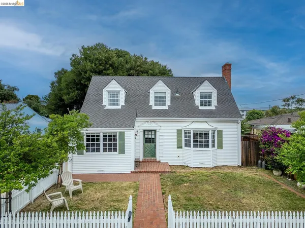 a view of a brick house with a yard