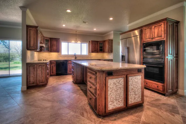a kitchen with stainless steel appliances granite countertop a stove and a sink