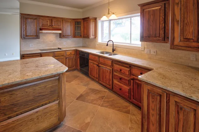 a kitchen with stainless steel appliances granite countertop wooden cabinets a sink and dishwasher