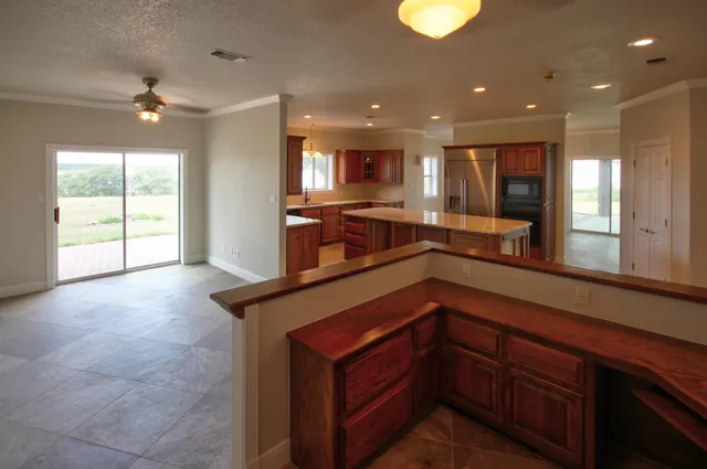 a kitchen with stainless steel appliances granite countertop a sink and stove top oven