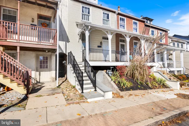 a front view of a house with large windows