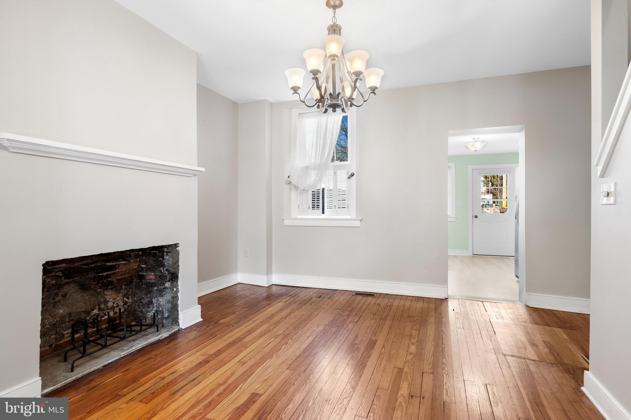 311 State Street Kennett Square, PA 19348 - Photo 11 of 37 a view of an empty room with wooden floor fireplace and a window
