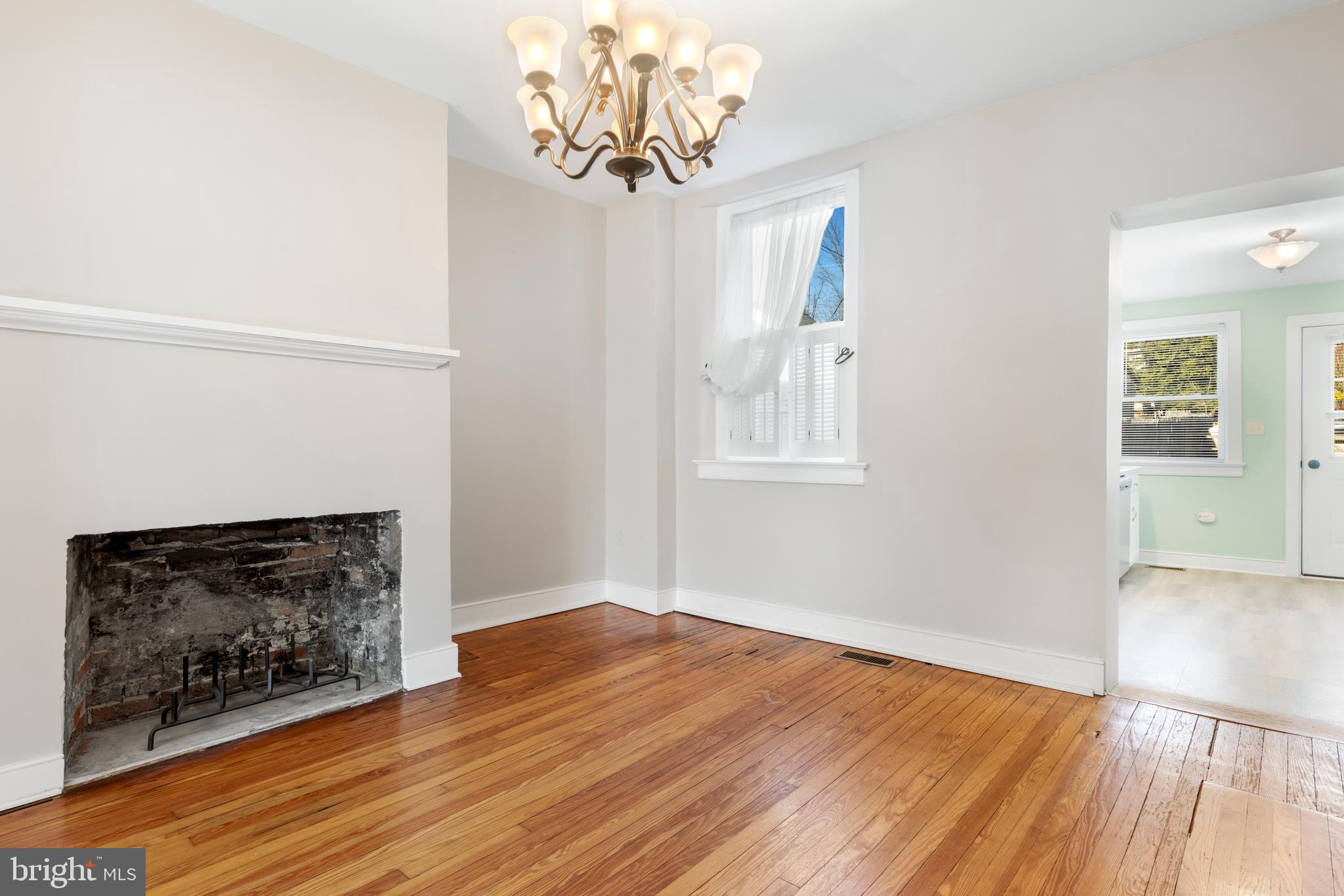 311 State Street Kennett Square, PA 19348 - Photo 12 of 37 an empty room with wooden floor a chandelier fan and windows