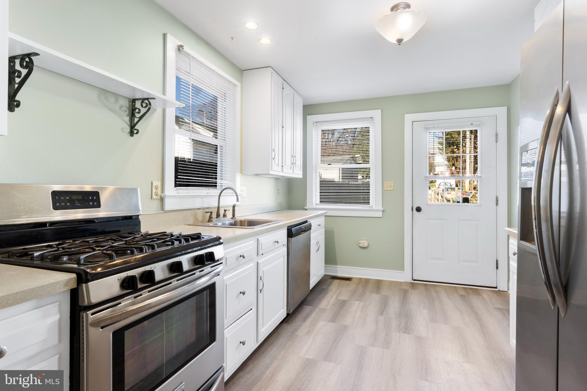 311 State Street Kennett Square, PA 19348 - Photo 17 of 37 a kitchen with stainless steel appliances a stove a sink and a refrigerator