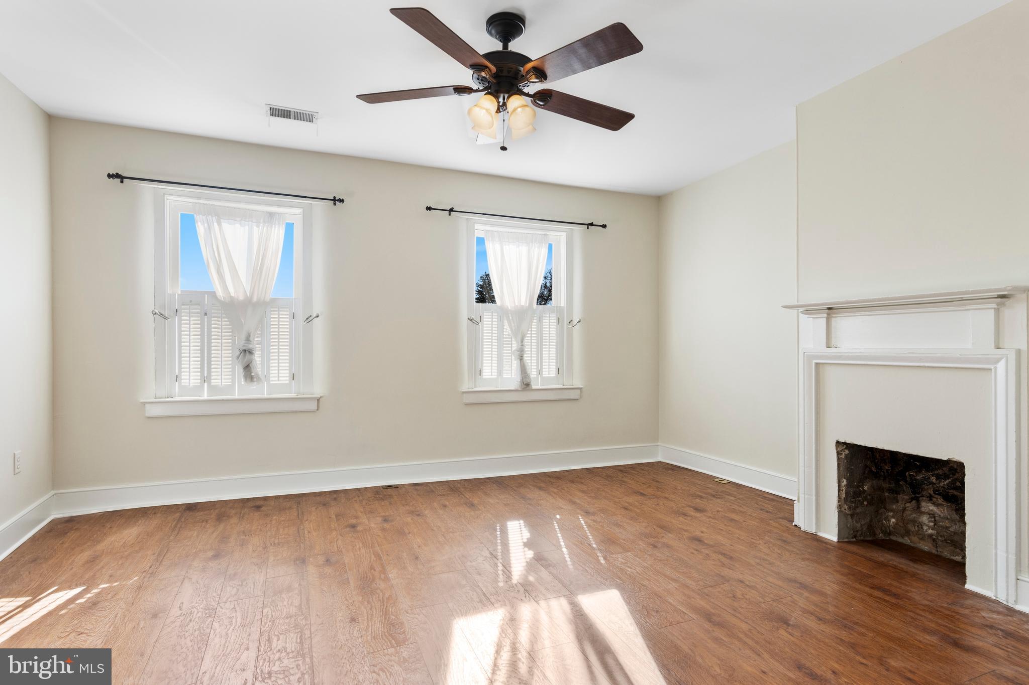 311 State Street Kennett Square, PA 19348 - Photo 24 of 37 a view of empty room with wooden floor and fan
