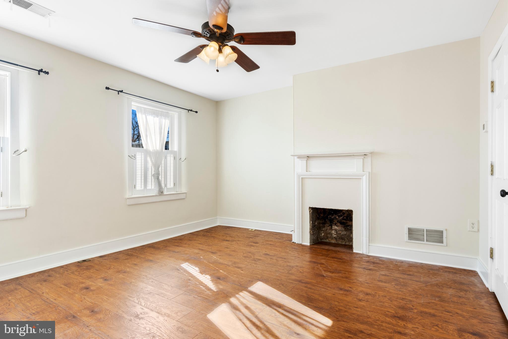 311 State Street Kennett Square, PA 19348 - Photo 25 of 37 a view of a livingroom with a fireplace a ceiling fan and wooden floor