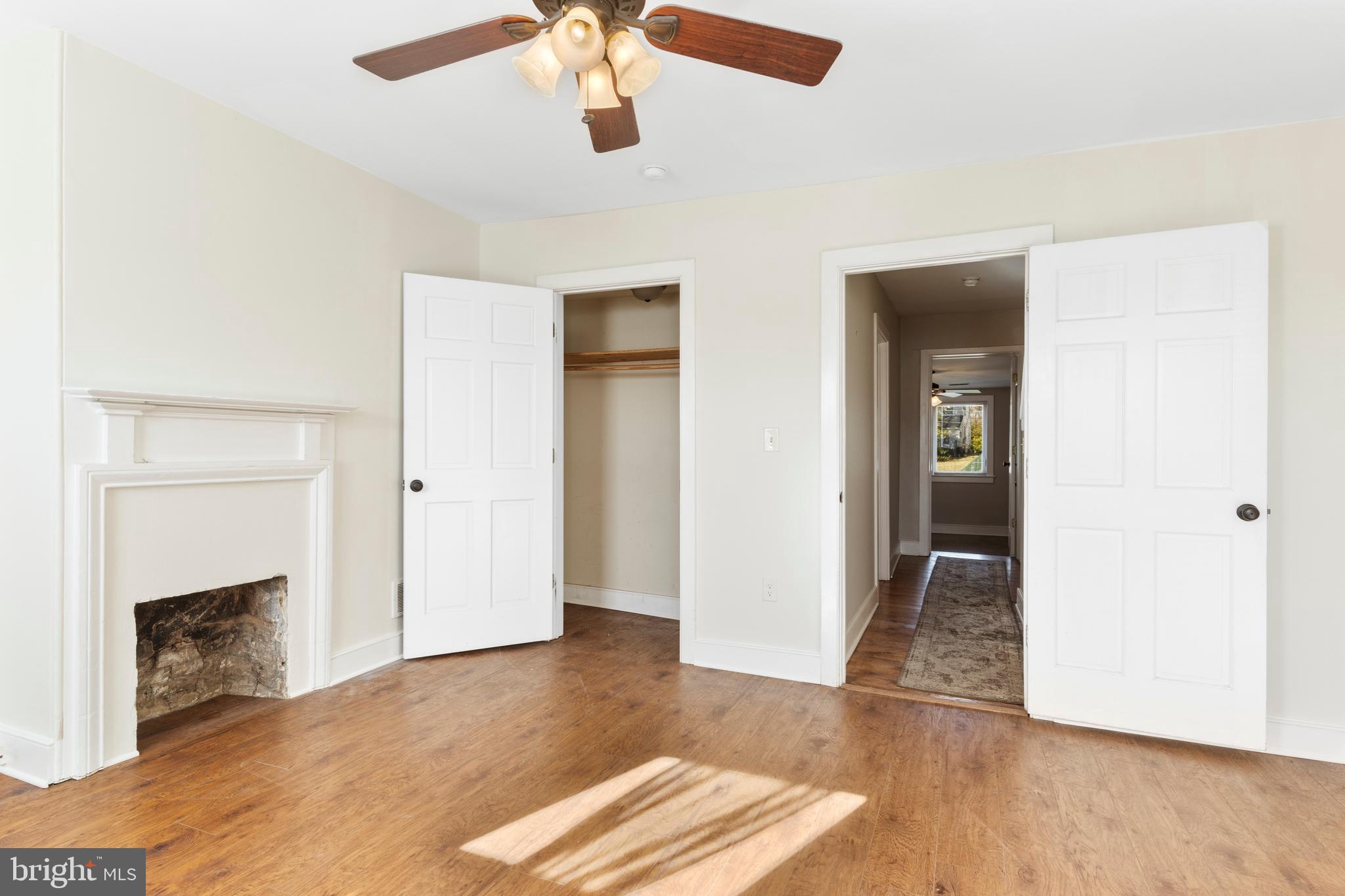 311 State Street Kennett Square, PA 19348 - Photo 27 of 37 an empty room with wooden floor and a fireplace