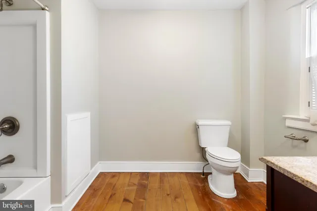 a white toilet sitting next to a bathroom sink